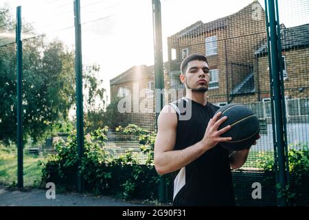 Serious basketball player at sports court Stock Photo