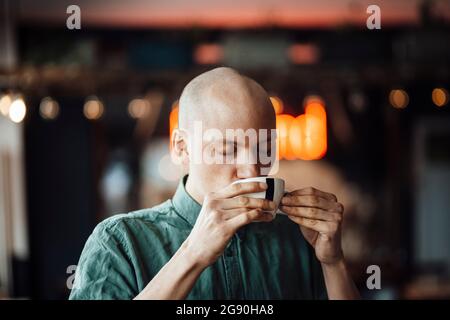 Male cafe owner drinking coffee Stock Photo