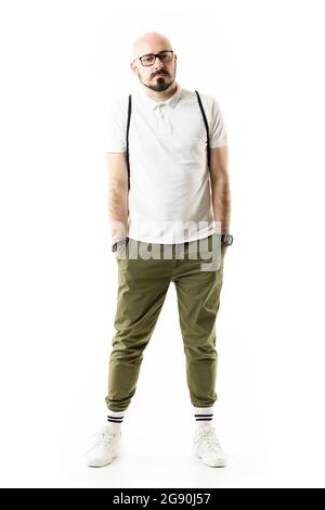 Bald nerdy stylish geek man with glasses posing with hands in pockets. Full length portrait isolated on white background Stock Photo