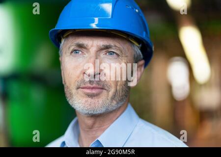 Male engineer with hardhat looking away Stock Photo