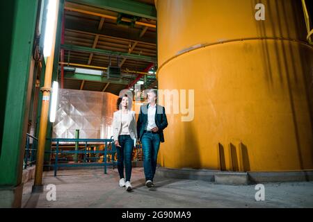 Male and female expertise walking at power station Stock Photo