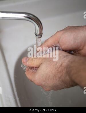 Men's hands are showing ways to wash their hands with a cleaning gel to prevent infectious diseases and prevent the virus Stock Photo