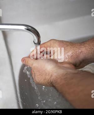 Men's hands are showing ways to wash their hands with a cleaning gel to prevent infectious diseases and prevent the virus Stock Photo