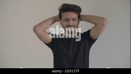 Closeup shot of a young smiling Indian guy Stock Photo