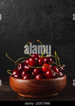Cherie on dark background / Focused fresh cherie on stone plate Stock Photo