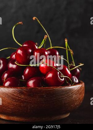 Cherie on dark background / Focused fresh cherie on stone plate Stock Photo