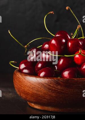 Cherie on dark background / Focused fresh cherie on stone plate Stock Photo