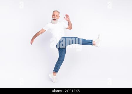 Full length body size view of nice funny cheerful man walking making step having fun isolated over light grey color background Stock Photo