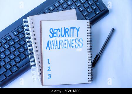 Text caption presenting Security Awareness. Internet Concept educating employees about the computer security Two Plain Lined Spiral Notebooks With Pen Stock Photo