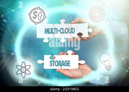 Conceptual display Multi Cloud Storage. Word Written on use of multiple cloud computing and storage services Hand Holding Jigsaw Puzzle Piece Stock Photo