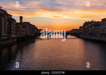 Historic bridge over the River Arno, silhouetted against beautiful sky in Florence, Tuscany, Italy Stock Photo