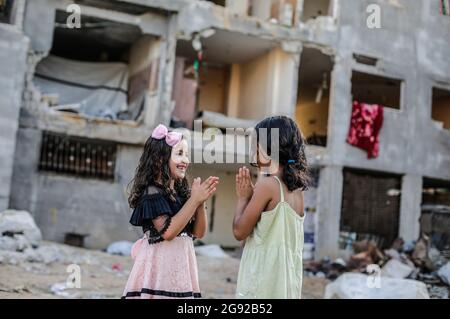Gaza City, Palestine. 22nd July, 2021. Two girls play outside their houses that were destroyed by the Israeli air strikes on the town of Beit Hanoun. Credit: SOPA Images Limited/Alamy Live News Stock Photo