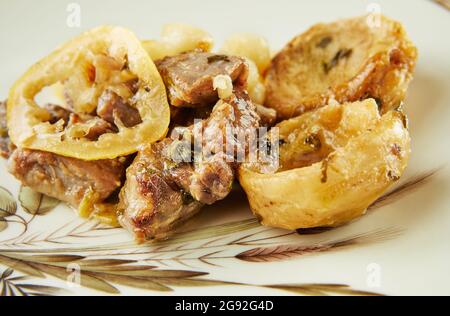 Lamb with lemon, artichokes and coriander stalks fried over low heat Stock Photo