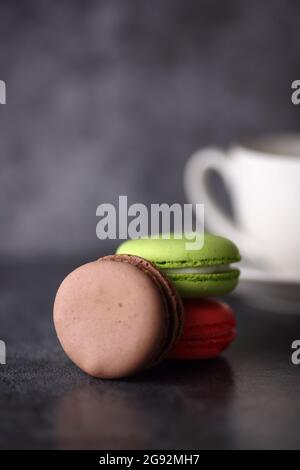 a close up pile of macaroons and a cup isolated on gray backgound Stock Photo