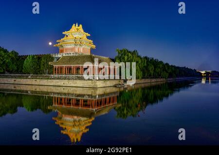 Beijing, China. 23rd July, 2024. Nightscape of the Turret of Palace Museum also known as the Forbidden City reflected in the lake waters in Beijing. Credit: SOPA Images Limited/Alamy Live News Stock Photo