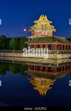 Beijing, China. 23rd July, 2024. Nightscape of the Turret of Palace Museum also known as the Forbidden City reflected in the lake waters in Beijing. Credit: SOPA Images Limited/Alamy Live News Stock Photo