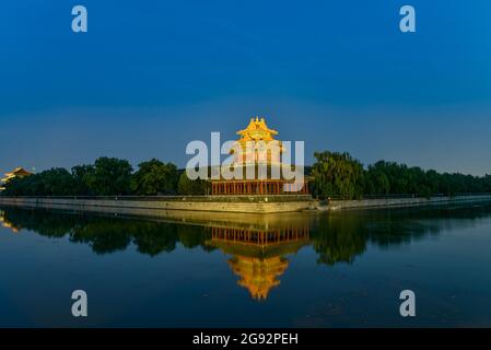 Beijing, China. 23rd July, 2024. Nightscape of the Turret of Palace Museum also known as the Forbidden City reflected in the lake waters in Beijing. Credit: SOPA Images Limited/Alamy Live News Stock Photo