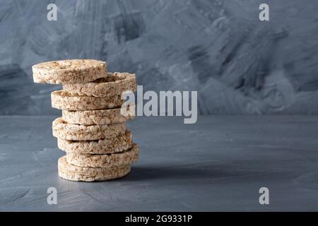 Heap of thin, crispy wholegrain rye breads isolated on gray background. Copy Space for text Stock Photo