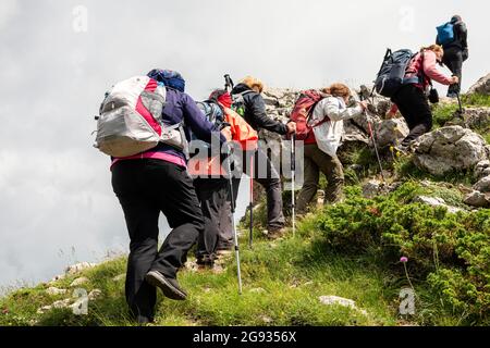 Group of female hikers traversing the Goats Wall or Chamois Wall on the European Pedestrian Route E-3 Path, UNESCO Biosphere Reserve, Bulgaria Stock Photo