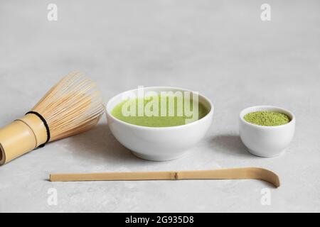 Matcha green tea. Set for a Japanese tea ceremony on a gray concrete background. Space for text. Stock Photo