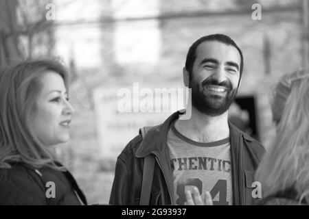 ISTANBUL, TURKEY - Mar 07, 2020: A grayscale shot of a group of Turkish people talking in Taksim Street, Istanbul Stock Photo