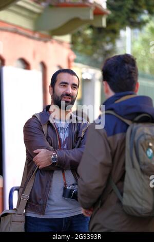 ISTANBUL, TURKEY - Mar 07, 2020: The young Turkish men talking about photography in Taksim Street, Istanbul Stock Photo