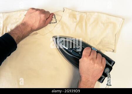 man ironed men's t-shirt close-up. top view Stock Photo