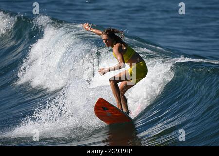 Chiba, Japan. 24th July, 2021. Stephanie Gilmore of Australia rides a wave during a training session at Tsurigasaki beach in Chiba, Japan, July 24, 2021. Credit: Du Yu/Xinhua/Alamy Live News Stock Photo