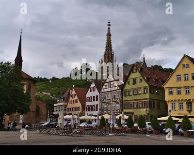 View of historic marketplace in the historic center of Esslingen with old buildings, the steeple of church Frauenkirche and vineyards in background. Stock Photo