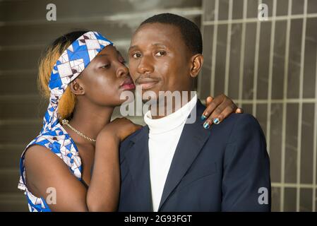 Young romantic person couple laughing standing in town. young smiling Young romantic person couple laughing standing in town. young smiling couple loo Stock Photo