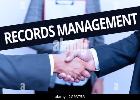 Sign displaying Records Management. Word Written on administration of records and documented information Two Professional Well-Dressed Corporate Stock Photo