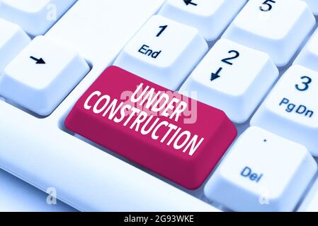 Hand writing sign Under Construction. Business overview project that is unfinished but actively being worked on Fixing Internet Problems Concept Stock Photo