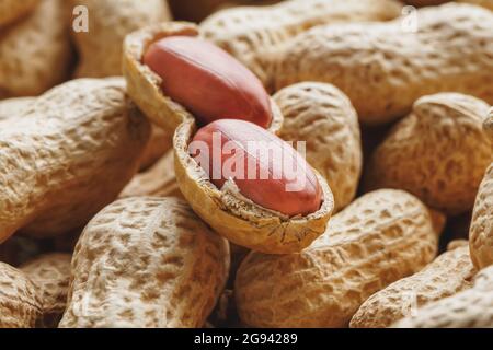 Peeled peanut on well peanuts. Uncleaned inshell peanuts. Peanuts, for background or textures. Stock Photo