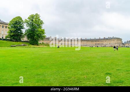 BATH, UK - JUNE 27, 2021: View of Royal Crescent in Bath, overlooking Royal Victoria Park. Stock Photo