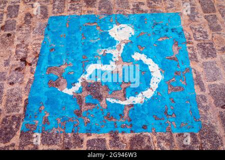 Parking space reserved for disabled drivers or drivers carrying disabled passengers. Stock Photo