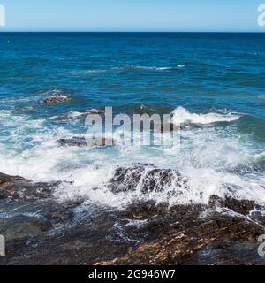 Wave breaking on rock. Stock Photo