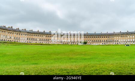 BATH, UK - JUNE 27, 2021: Panoramic view of Royal Crescent in Bath, overlooking Royal Victoria Park. Stock Photo