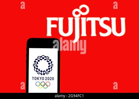 Spain. 20th July, 2021. In this photo illustration a Tokyo 2020 Olympic Games logo seen displayed on a smartphone with a Fujitsu Limited logo in the background. (Credit Image: © Thiago Prudencio/SOPA Images via ZUMA Press Wire) Stock Photo