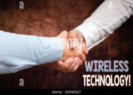 Sign displaying Wireless Technology. Business concept a technology that allows wireless communication Two Professional Well-Dressed Corporate Stock Photo