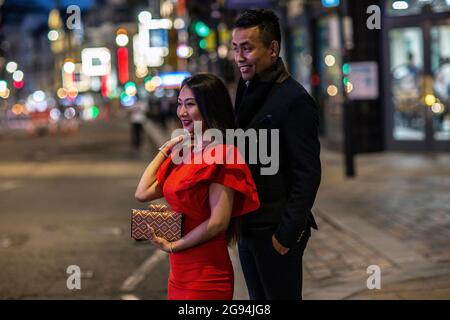 Chinese couple out on date night in Soho . Boris Johnson's 'freedom day' ending over a year of COVID-19 lockdown restrictions in England People going Stock Photo