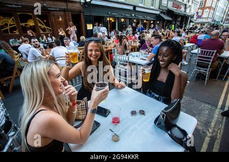 Diverse group of young people celebrating  freedom day' ending over a year of COVID-19 lockdown restrictions in Soho , London ,England Stock Photo