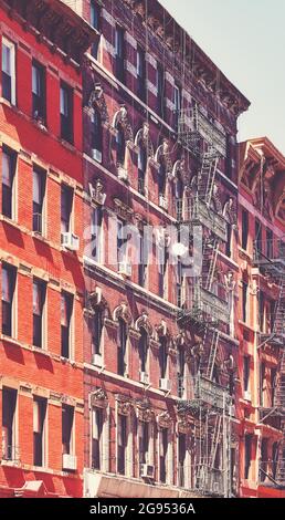 Old buildings with fire escapes, color toning applied, New York City ...