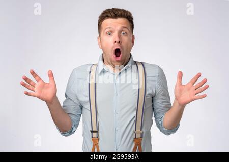 Man with shocked, amazed expression with opened mouth looking at camera Stock Photo