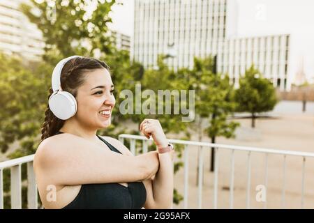 Smiling curvy woman stretching  Stock Photo