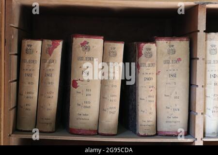 Ancient Italian law books from the 1800s in an old bookshelf Stock Photo