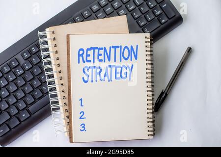 Sign displaying Retention Strategy. Business idea activities to reduce employee turnover and attrition Two Plain Lined Spiral Notebooks With Pen And Stock Photo