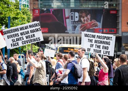 Manchester, UK. 24th July, 2021. Hundreds of protesters with anti COVID19 vaccination placards descend on the city. People march through Piccadilly for a global Worldwide Rally For Freedom demonstration. Credit: Andy Barton/Alamy Live News Stock Photo