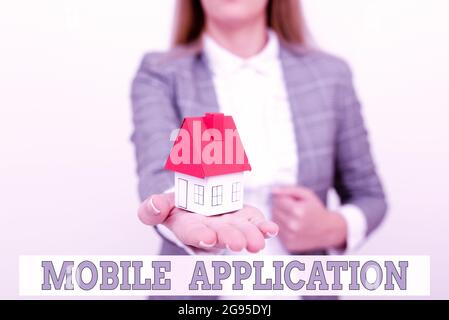 Handwriting text Mobile Application. Word for application software designed to run on a mobile device A Young Lady Orbusinesswoman Holding Stock Photo