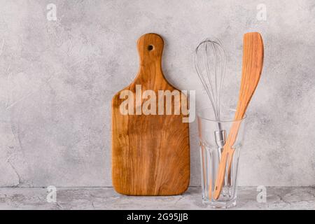 Kitchen utensils for eating and cooking on a light table. Stock Photo