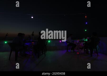 July 23, 2021: The pictures show a group of Syrian youths sitting on the top of Jabal Al-Arbaeen overlooking the city of Idlib and its countryside, where the mountain was a tourist destination before the Syrian revolution because of its beautiful and strategic location, after which it was subjected to intense bombardment by the regime forces, which led to the destruction of many buildings in it. Despite that, young people still go to spend Some time there despite the danger of bombing (Credit Image: © Moawia Atrash/ZUMA Press Wire) Stock Photo